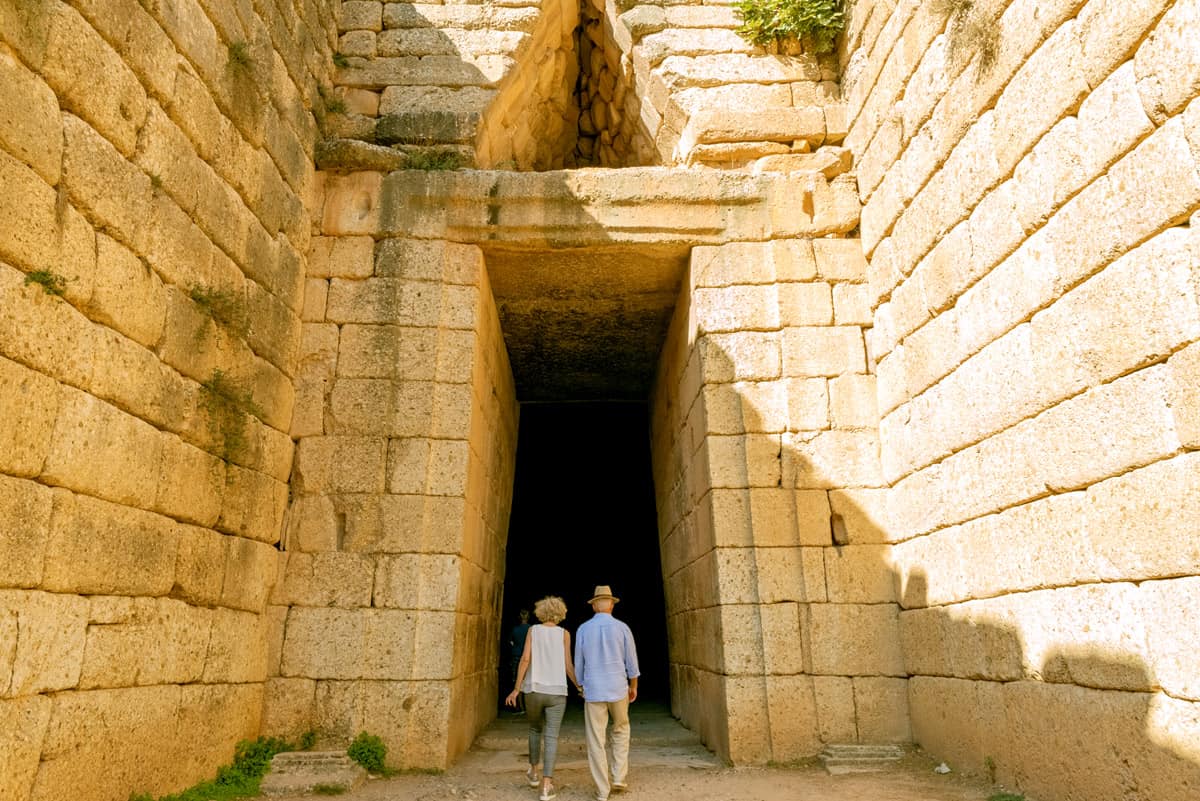  two tourists enter the tombs of Mycenae