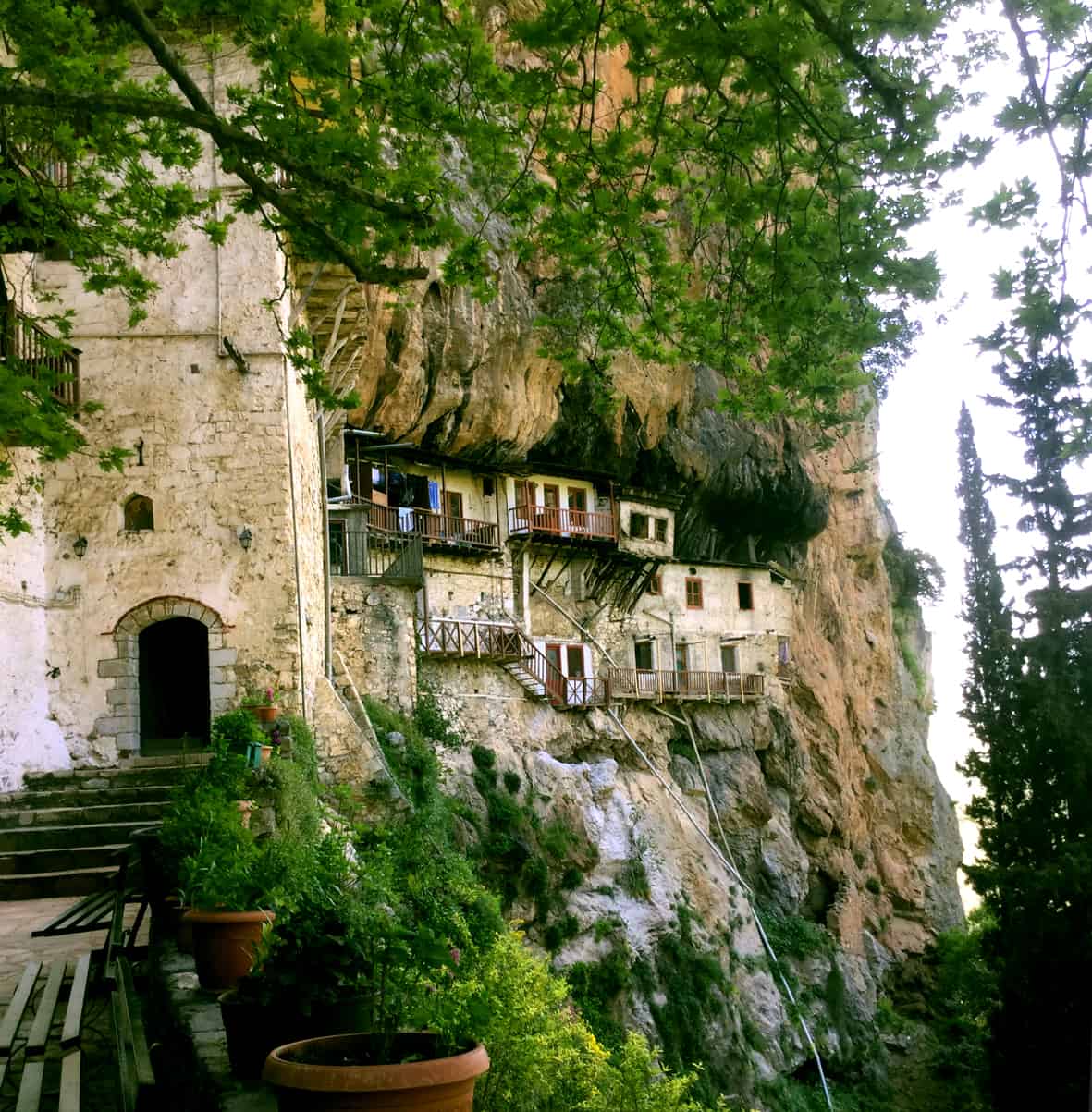 private day tours from Athens to the entrance to the monastery in a cliff with the building on the cliff edge